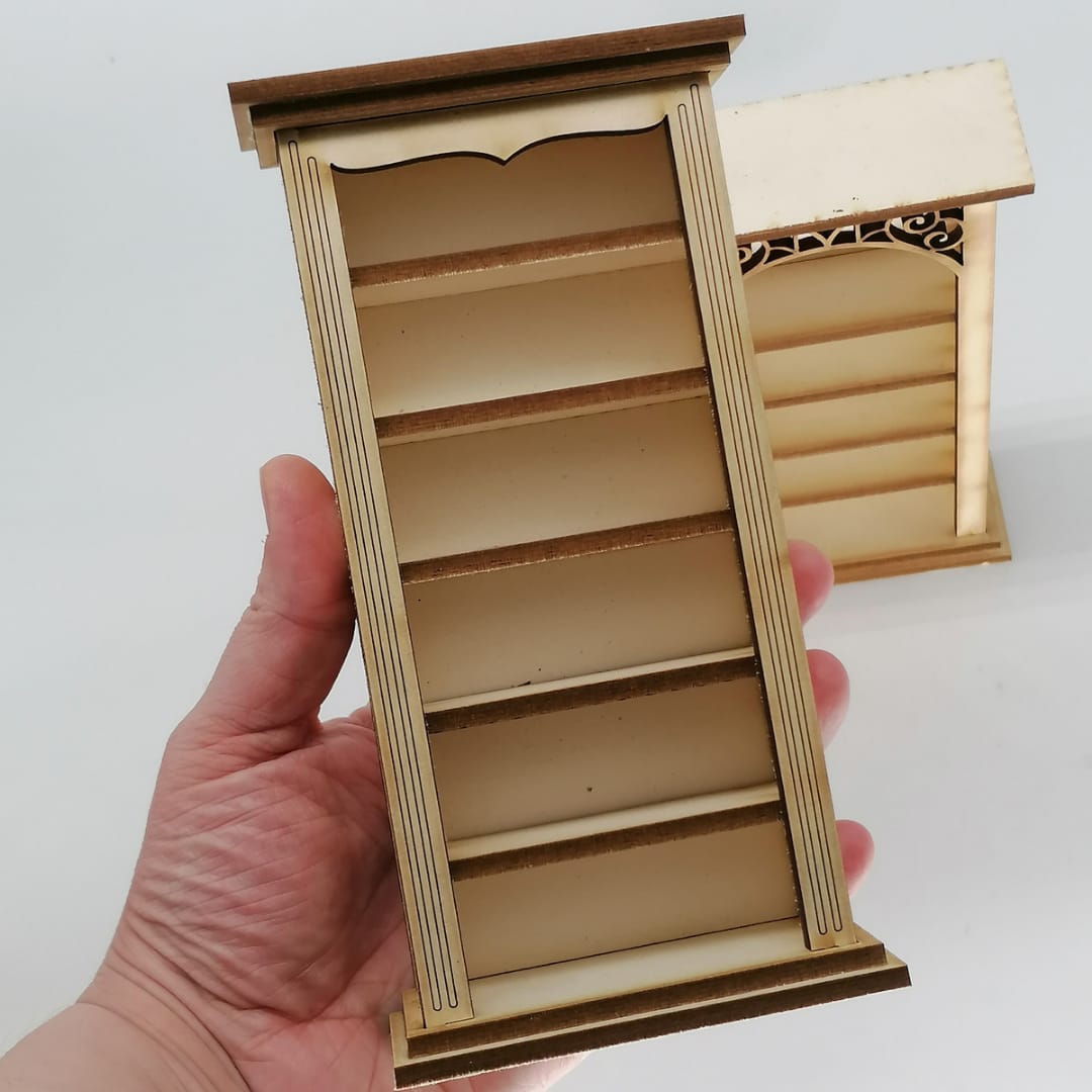 a hand is holding a large metal shelf
