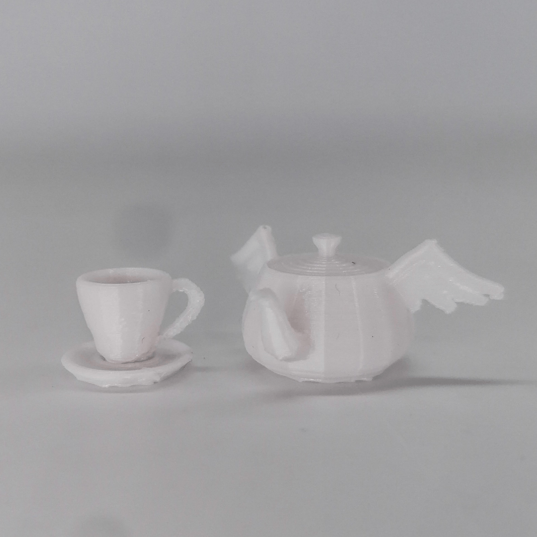 a couple of white vases sitting on top of a white table 
