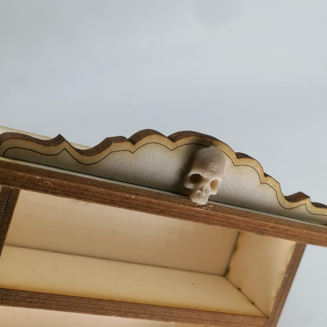 a cat laying on top of a wooden bench 