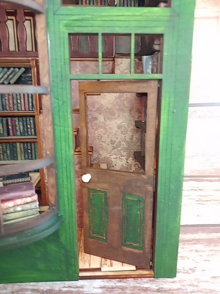 a green refrigerator is sitting in a room 